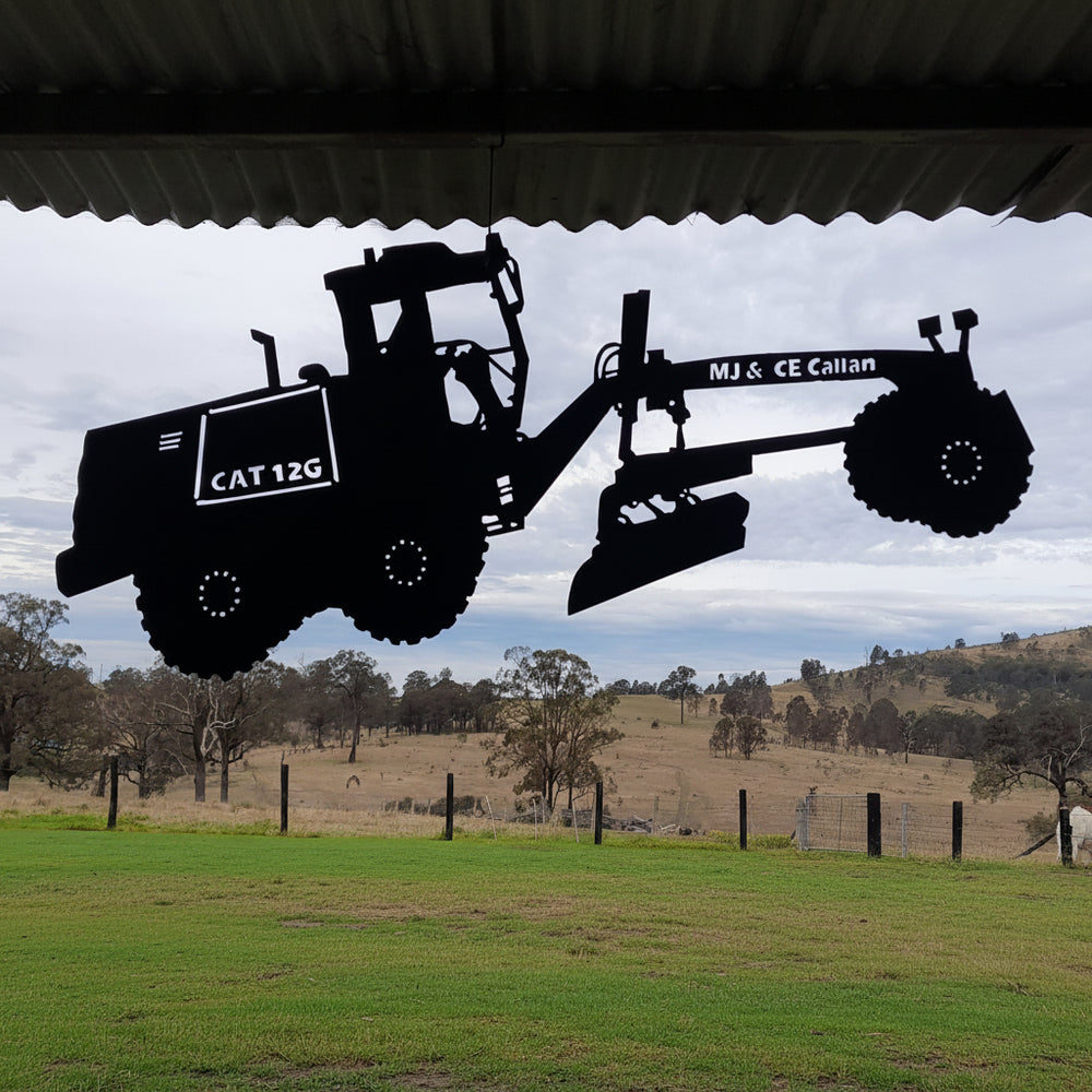 A machinery sign, cut to match the grader it belongs to.